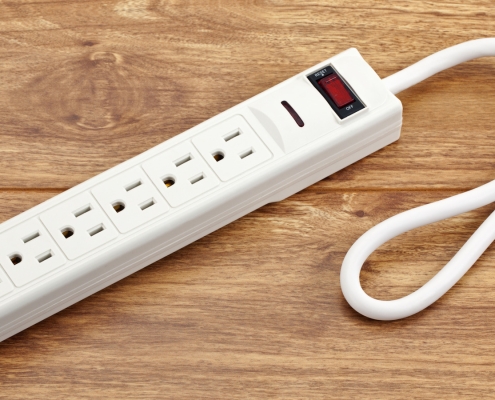 Why Some Power Strips Have A Reset Button (And When To Use It)